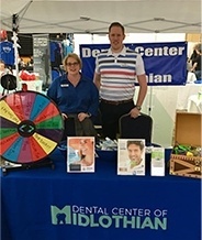 Dentist and team members at community event