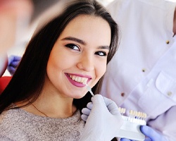 woman getting treatment after paying cost of veneers in Midlothian