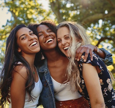 Group of friends smiling together outside