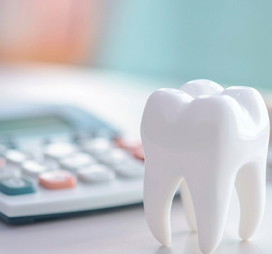 Large model tooth next to calculator