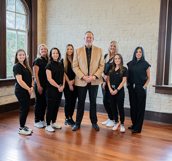 Dr. Phillip Johnson and dental team smiling