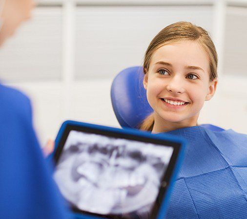 Young girl in dental chair smiling