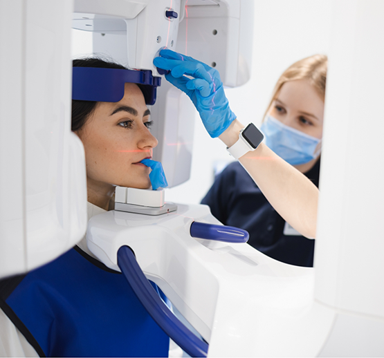 Female patient about to have mouth scanned with cone beam scanner