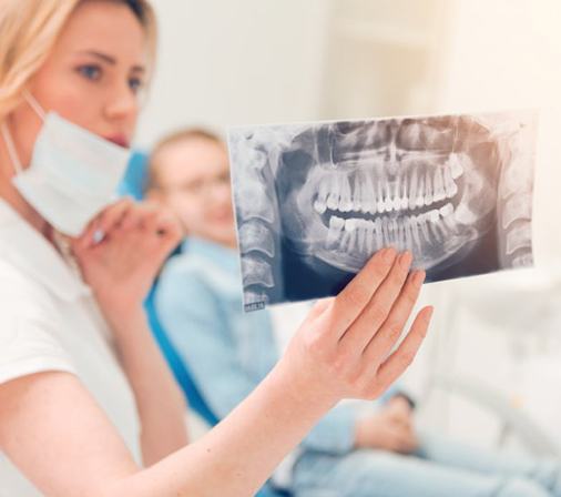 Dentist showing patient his X-ray during a dental checkup
