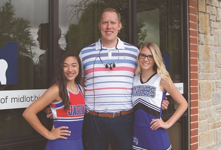 Dr. Johnson and cheerleaders from local schools