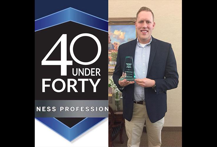 Dr. Johnson receiving his 40 under 40 plaque