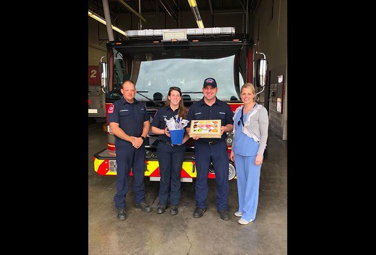 Dentist and firemen at community event