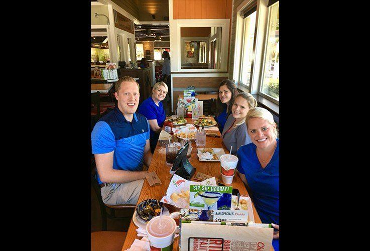 Dentist and team members at restaurant