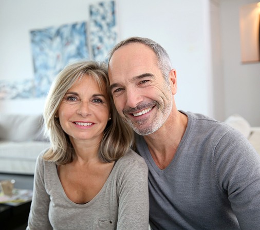 happy couple sitting in their living room