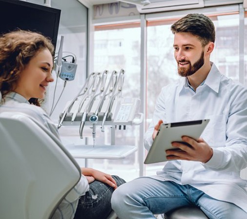 dentist showing a tablet to a patient