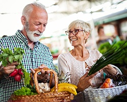 An elderly couple buying healthy foods for their meals