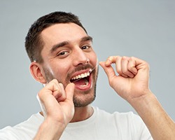 Man flossing his teeth