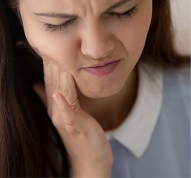 Close-up of woman looking concerned due to toothache