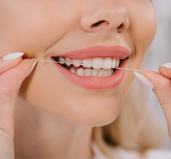 Close-up of woman flossing her teeth