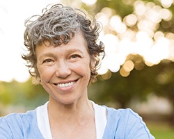 woman smiling after getting dental implants in Midlothian 