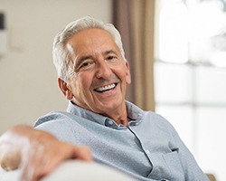 man smiling after getting dental implants in Midlothian