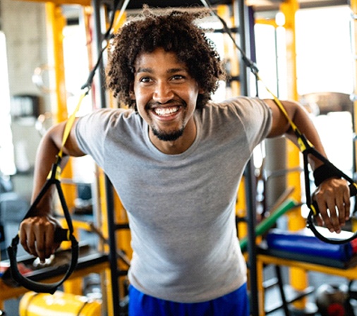 person smiling and working out