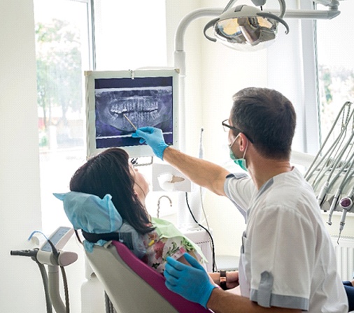 dentist showing a patient their X-rays