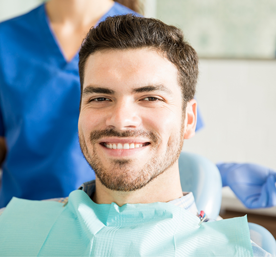 Close-up of man in dental chair smiling