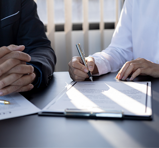 Two people looking at form on clipboard