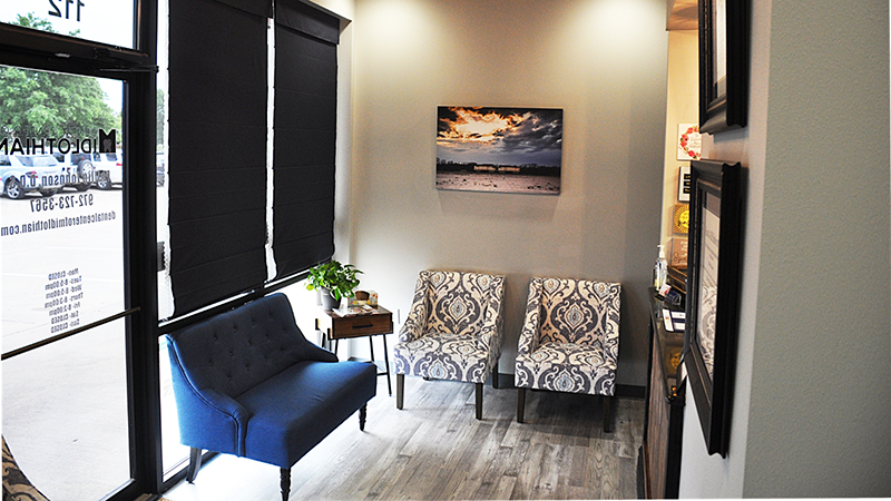 Blue chair and two patterned chairs in waiting room