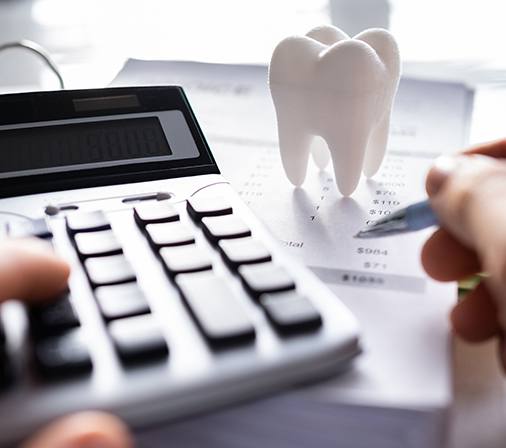 A patient calculating the cost of their dental care