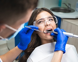 A dentist performing a root canal on a patient