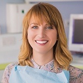 Woman in dental chair with healthy smile