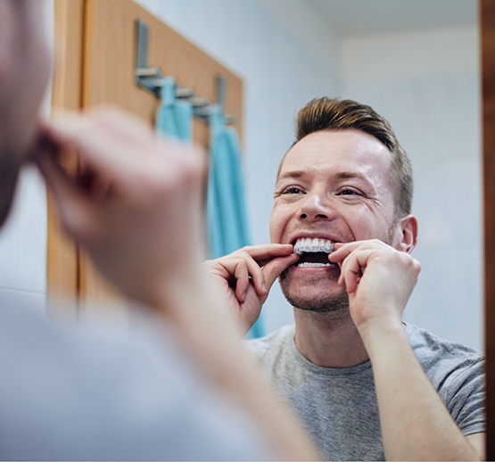 Man putting in tray for take-home whitening