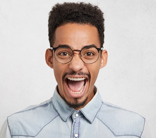happy person smiling against a gray background