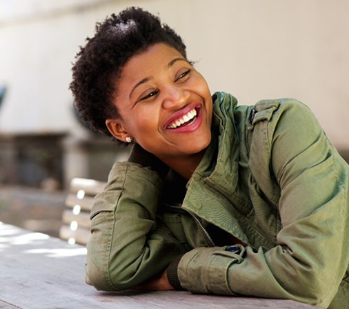 person lounging on park table and smiling