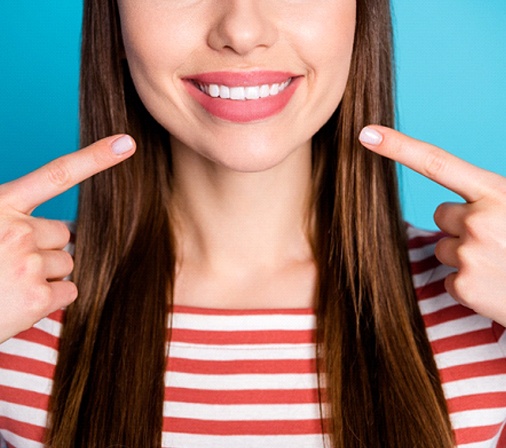 woman smiling after paying the cost of veneers in Midlothian