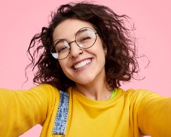 woman smiling after paying cost of veneers in Midlothian