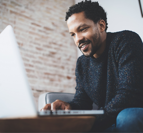 Man on couch looking at laptop