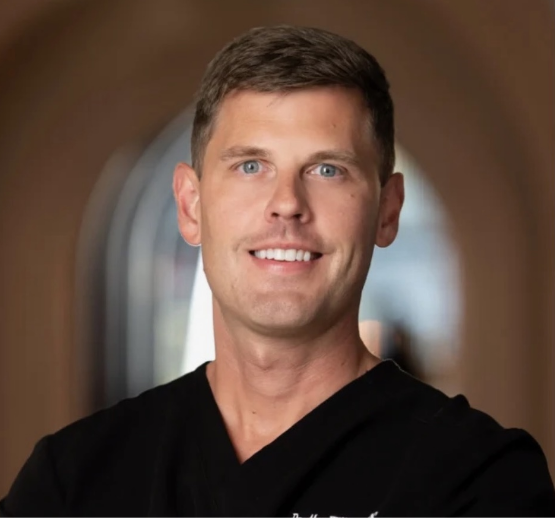 Dr. Phillip Johnson and dental team smiling