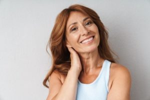 Woman with brown hair smiling with dental implants