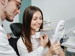 Patient and dentist looking at veneers. 